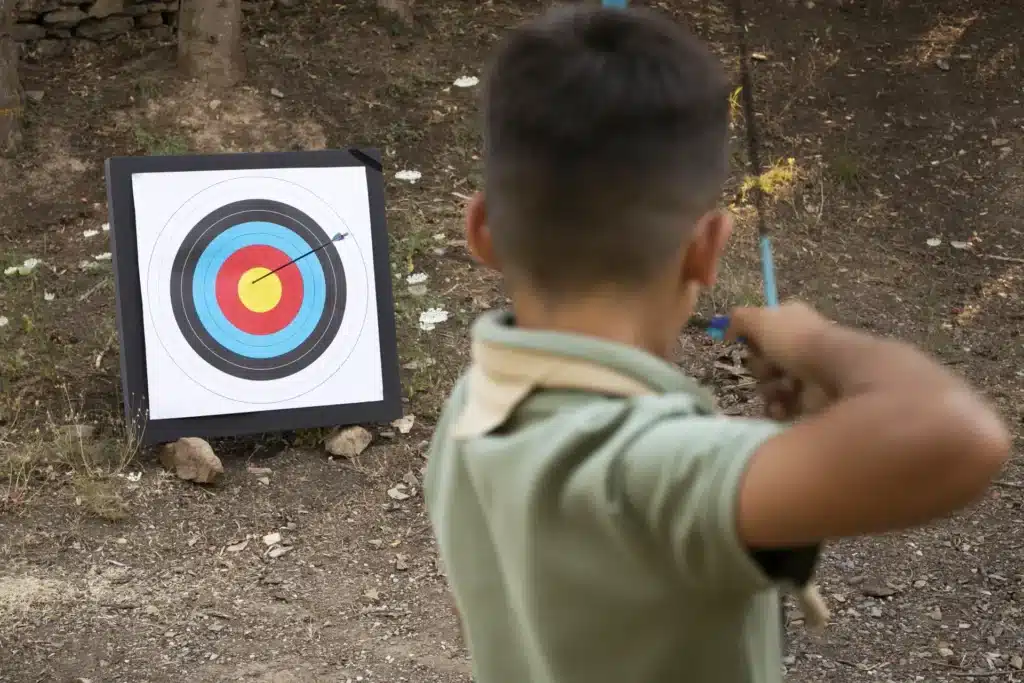A boy hits a bullseye while practicing archery