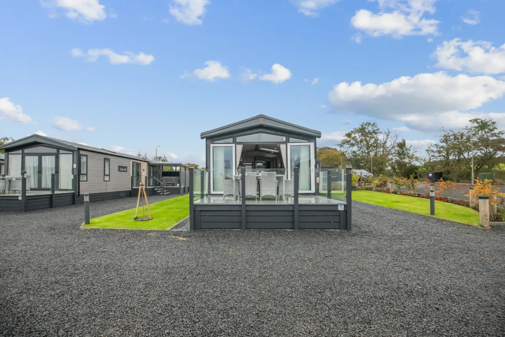 Exterior of Single Lodge 7 with decking and gravel parking