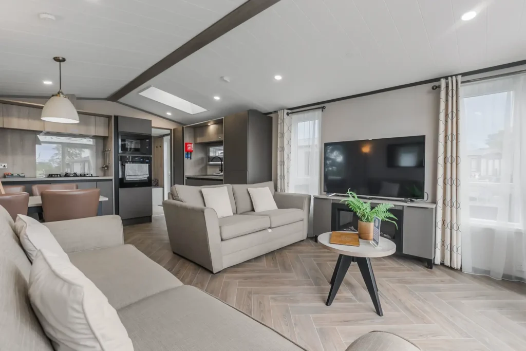 Living area in Single Lodge 13 with sofa and TV