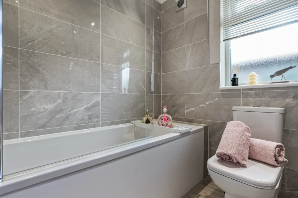 Bathroom in Twin Lodge 5 with bath and marble-effect tiling