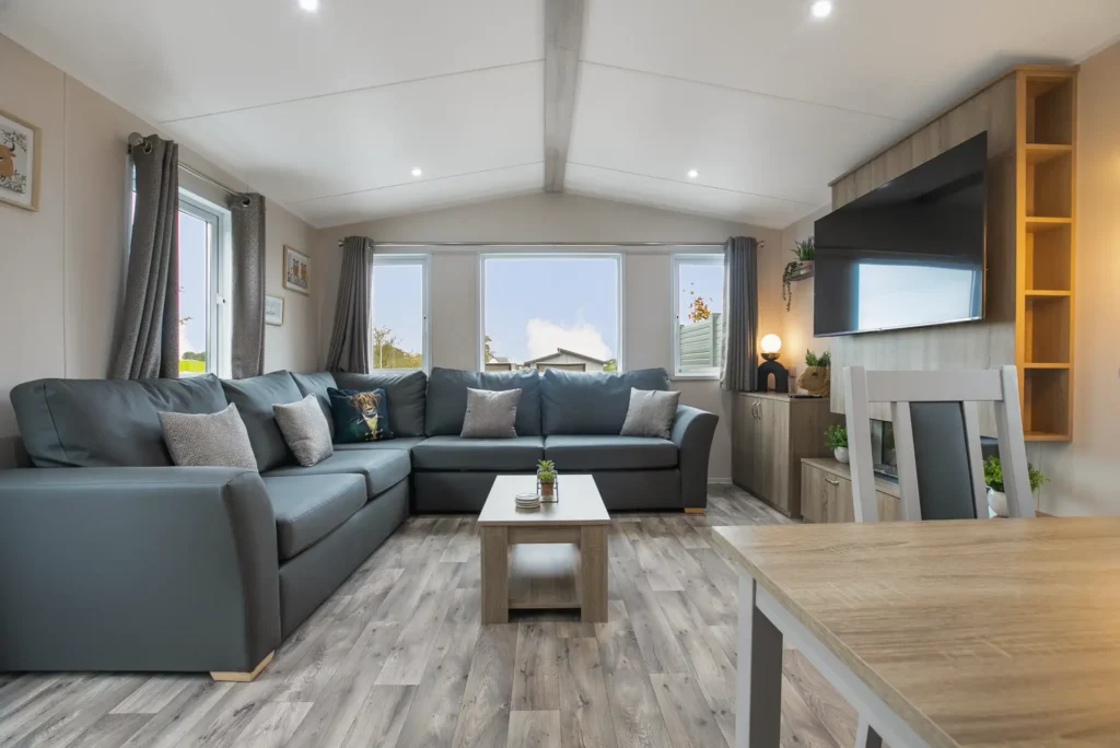 Living area in Accessible Lodge 14 with corner sofa