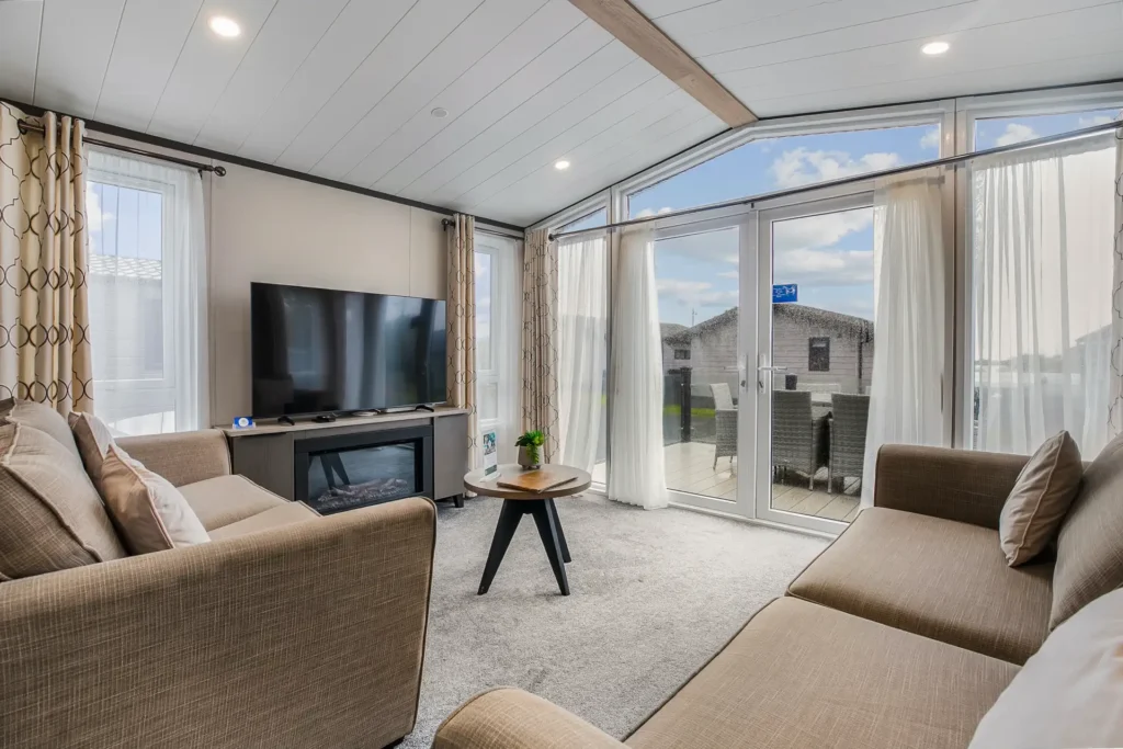 Living area in Single Lodge 8 with sofas and TV
