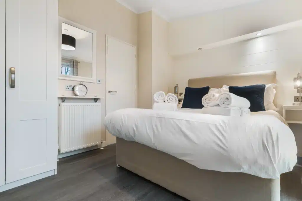 Bedroom in Twin Lodge 1 with double bed and storage